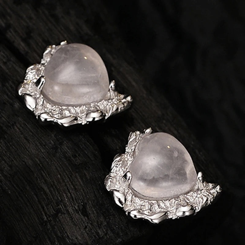 Heart shaped silver earrings with rose quartz.