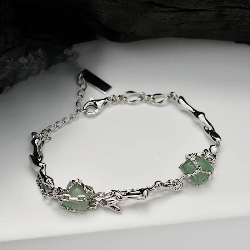 Silver bracelet with green jades.