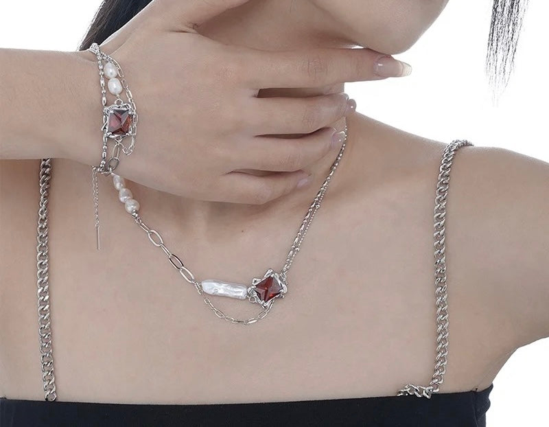 Necklace with baroque pearl and ruby crystal.