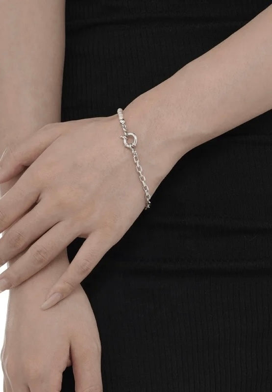 Silver pearl bracelet with big buckle.