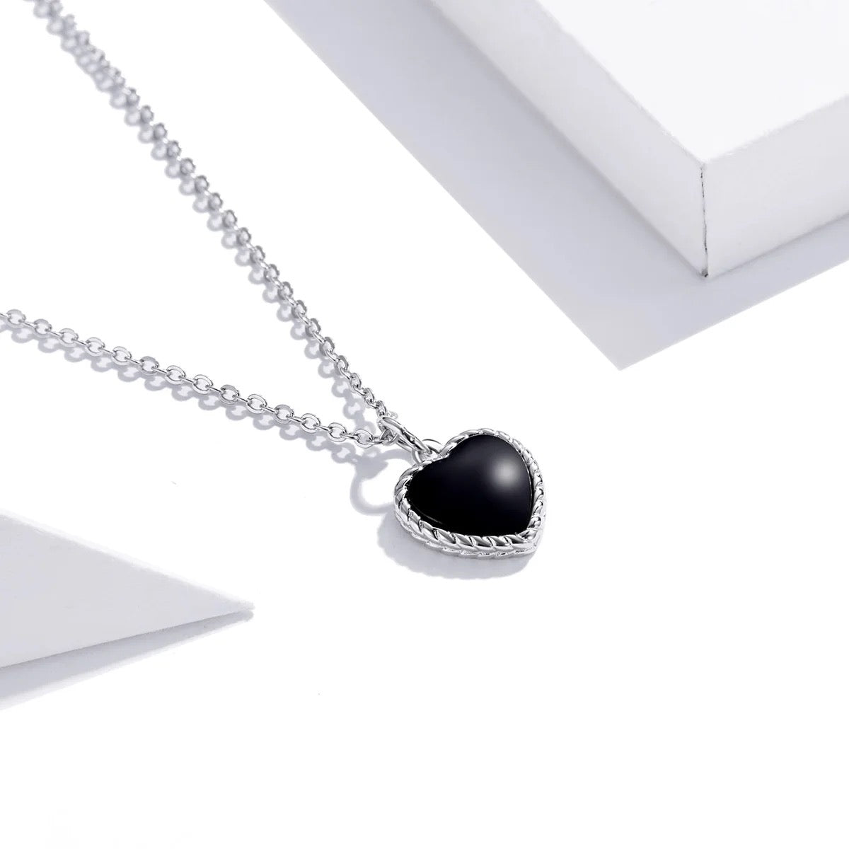Silver necklace with black heart