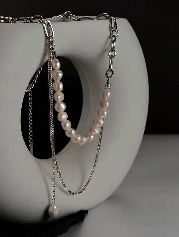 Necklace with chain and pearls.