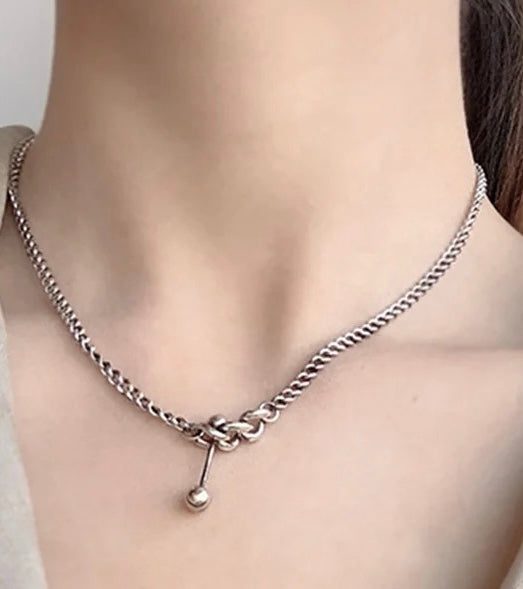 Silver necklace with decorative elements.
