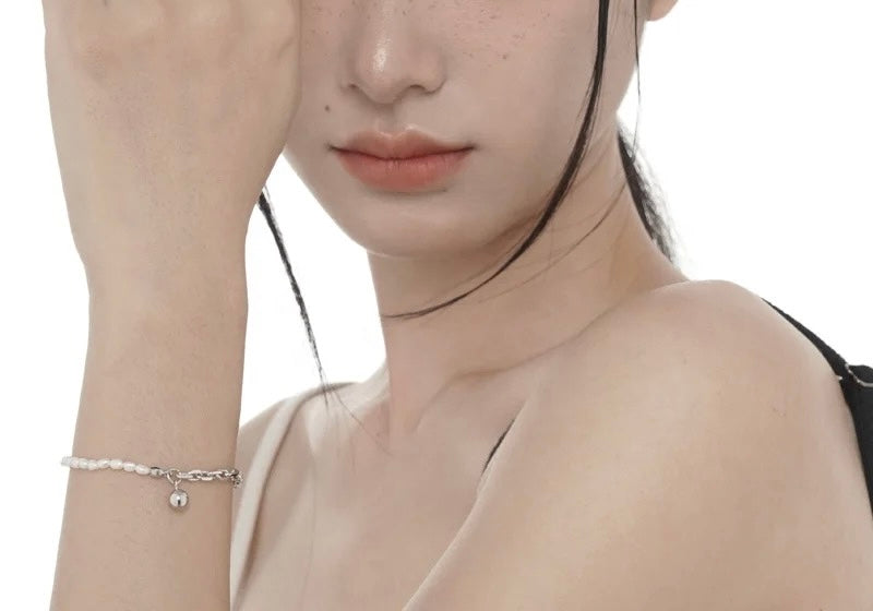 Silver pearl bracelet with big buckle.