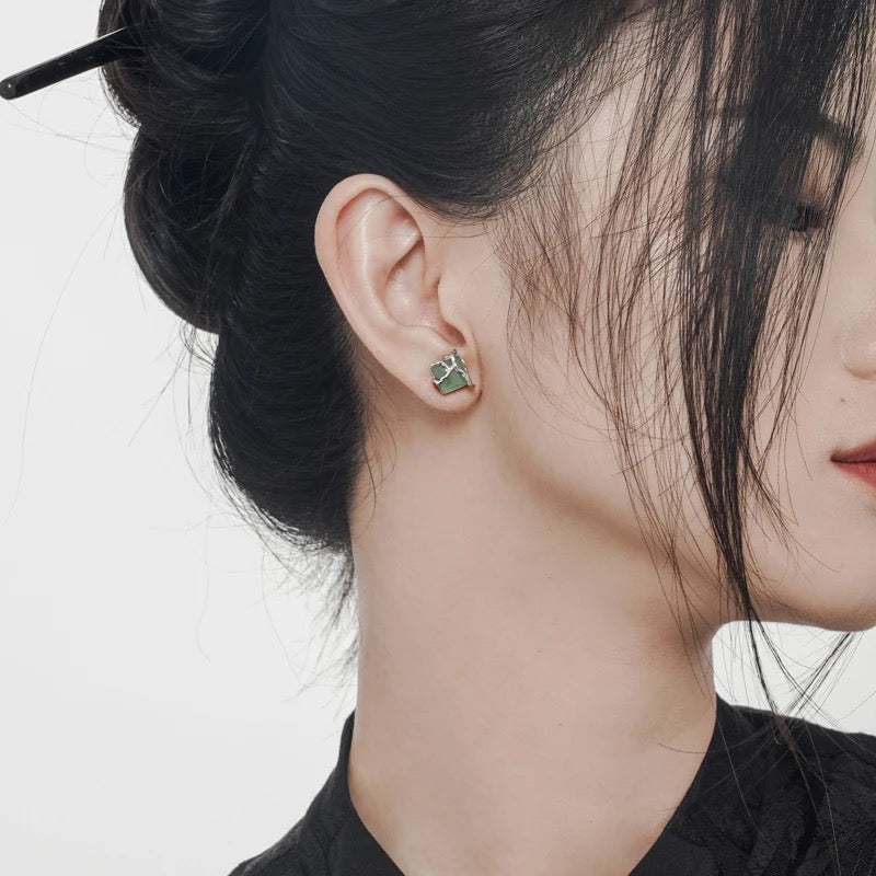 Earrings with green jade stone.