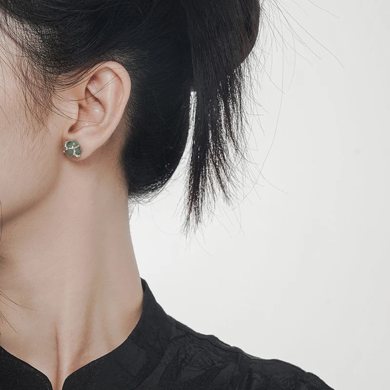 Earrings with green jade stone.