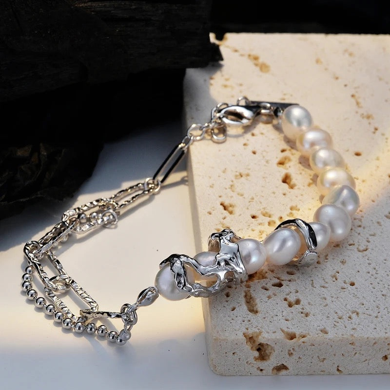 Silver irregular bracelet with pearls.