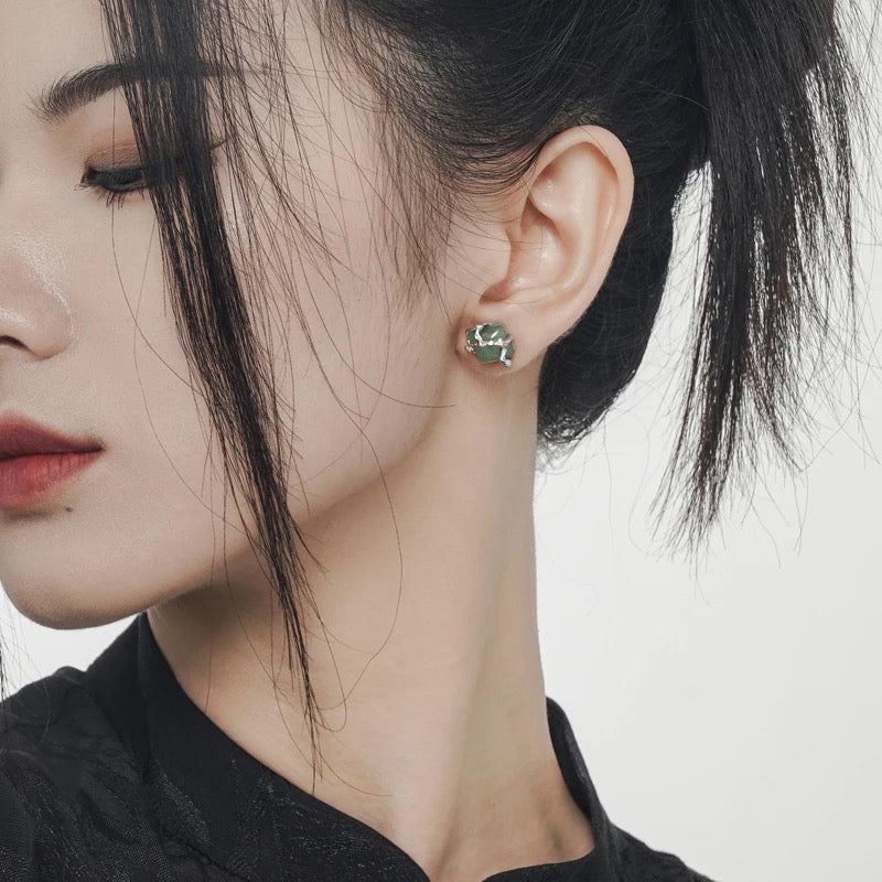 Earrings with green jade stone.