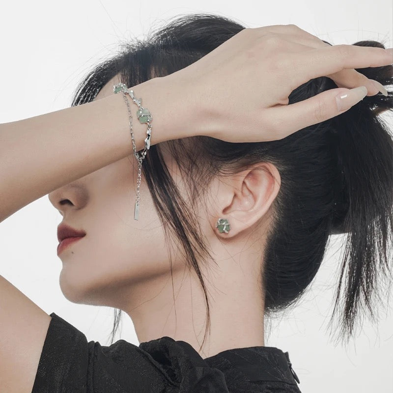 Silver bracelet with green jades.