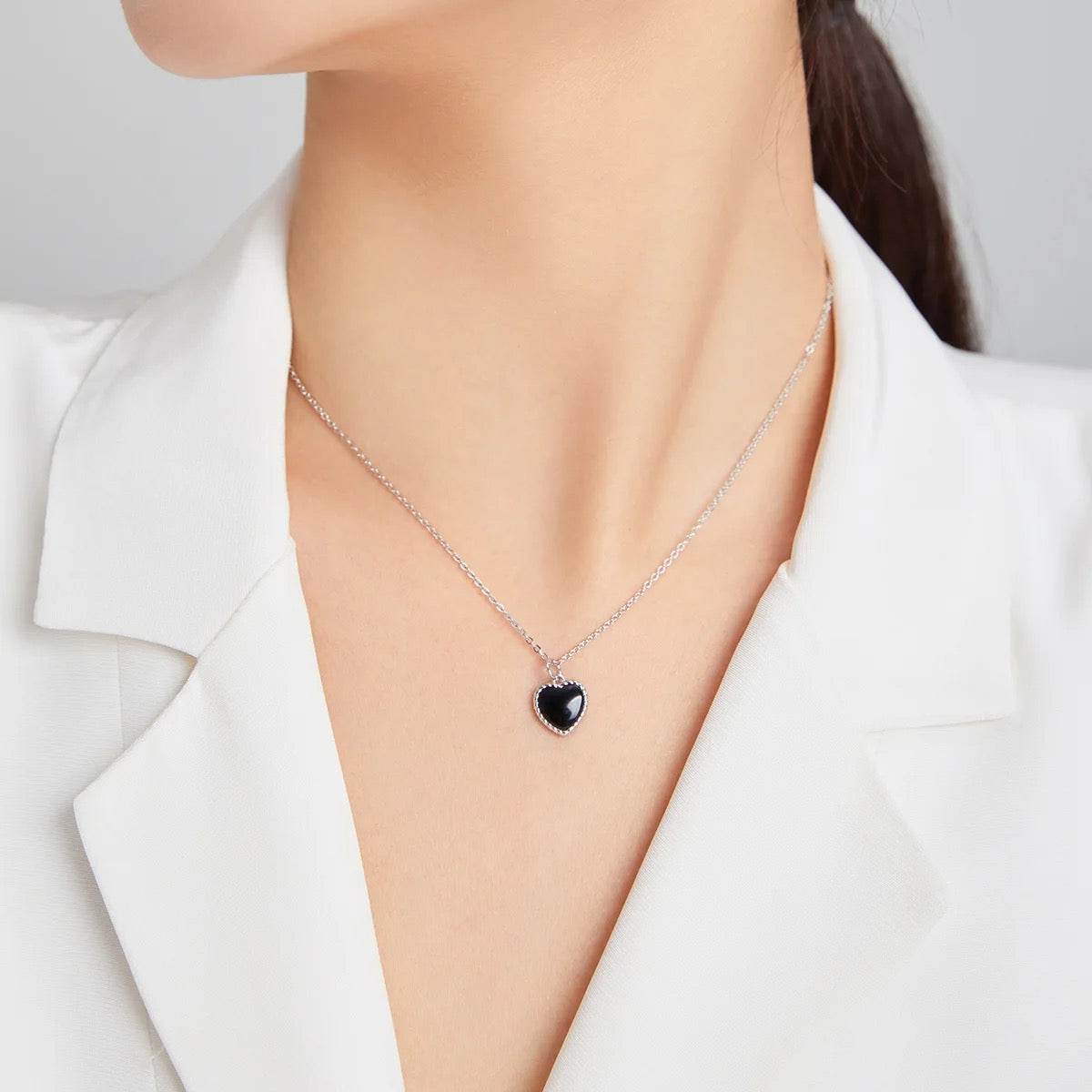 Silver necklace with black heart