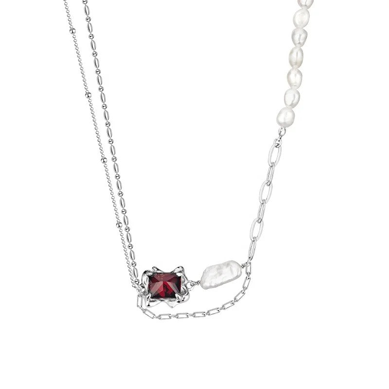 Necklace with baroque pearl and ruby crystal.