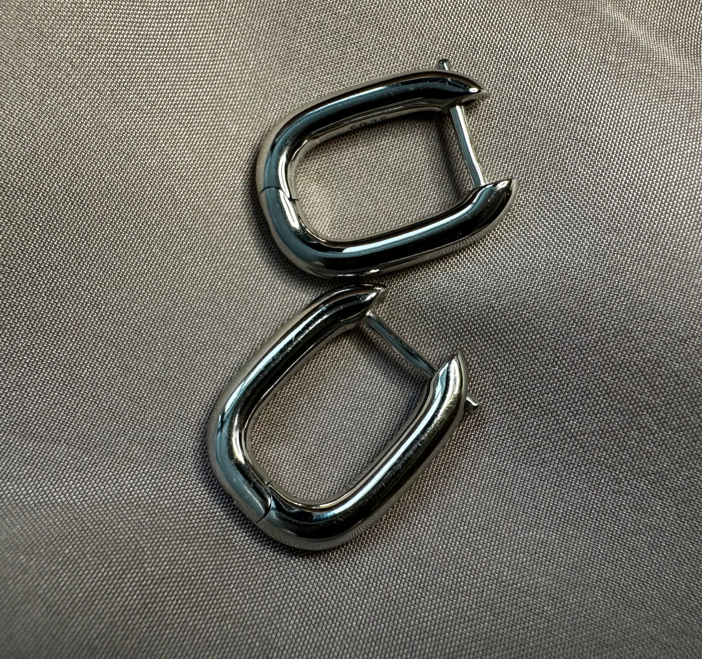 Silver earrings.