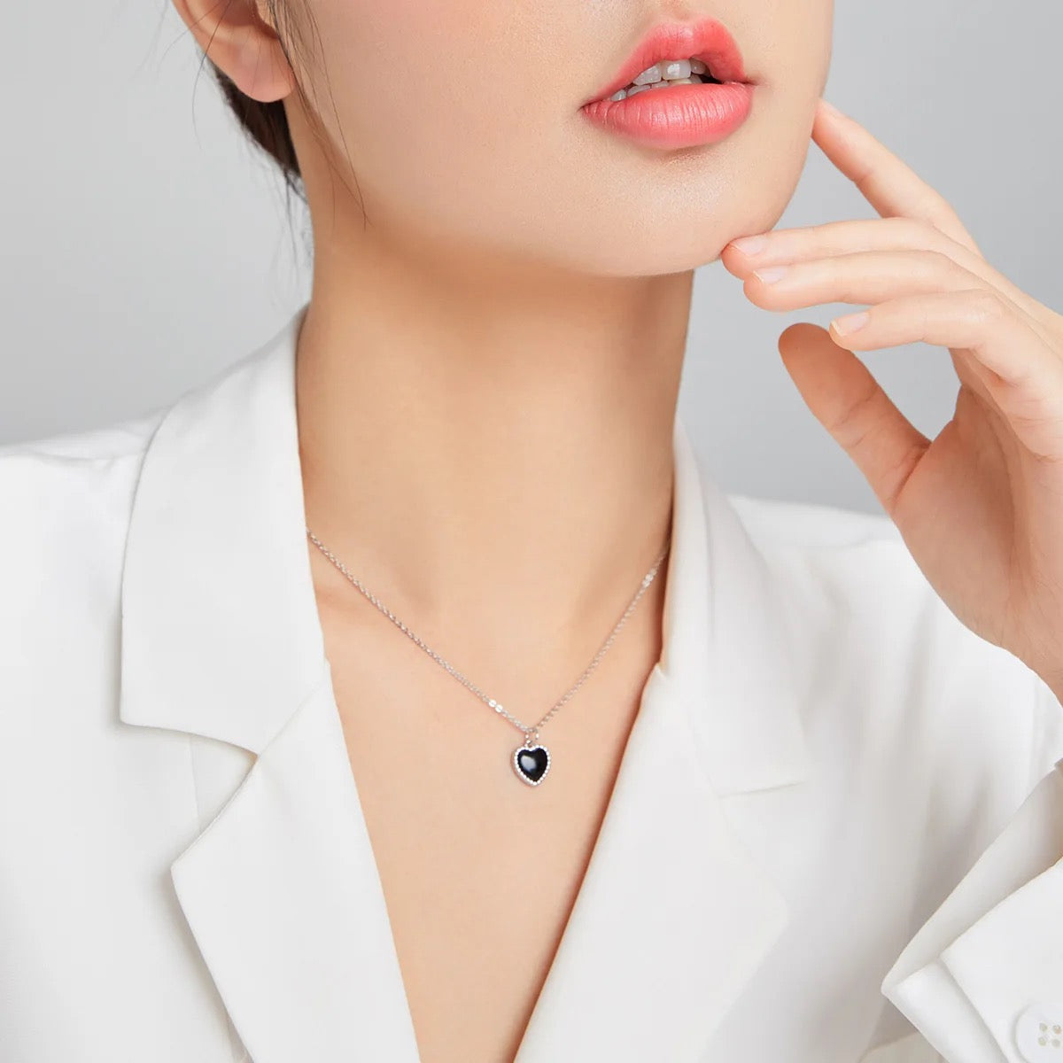 Silver necklace with black heart