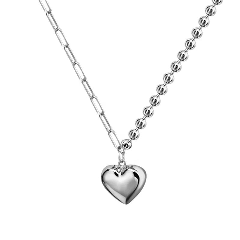 Silver necklace with heart pendant.
