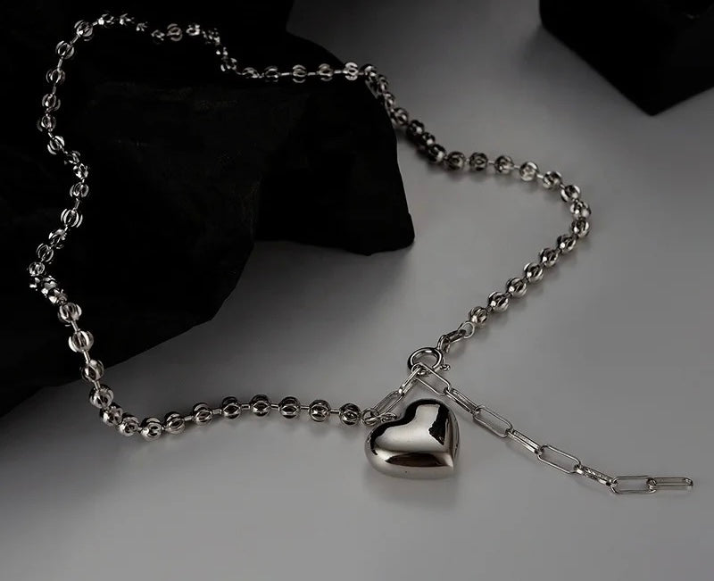 Silver necklace with heart pendant.