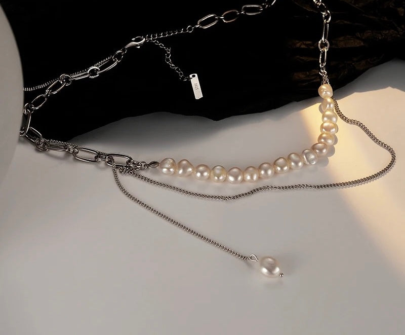 Necklace with chain and pearls.