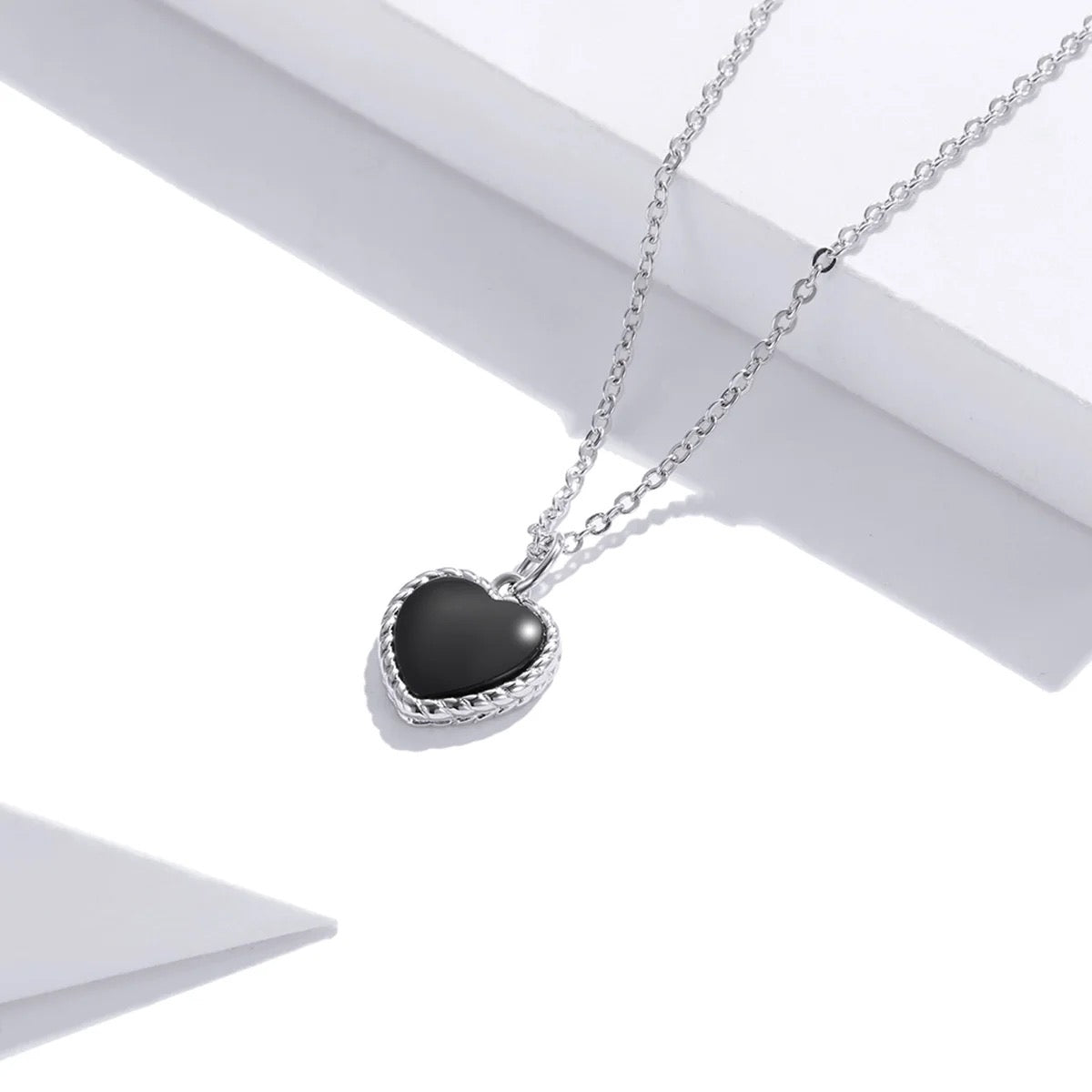 Silver necklace with black heart
