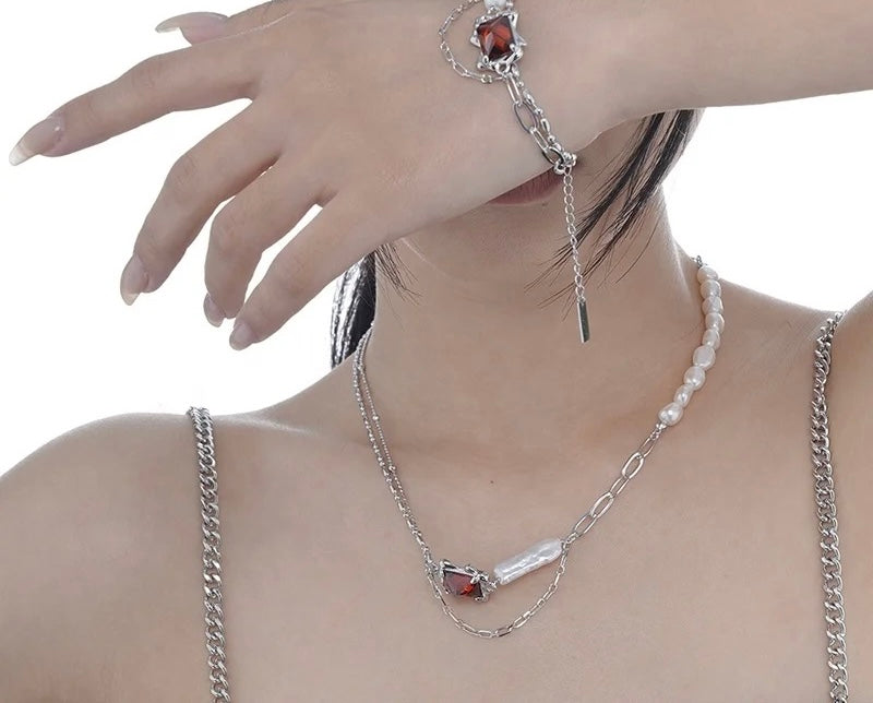 Necklace with baroque pearl and ruby crystal.