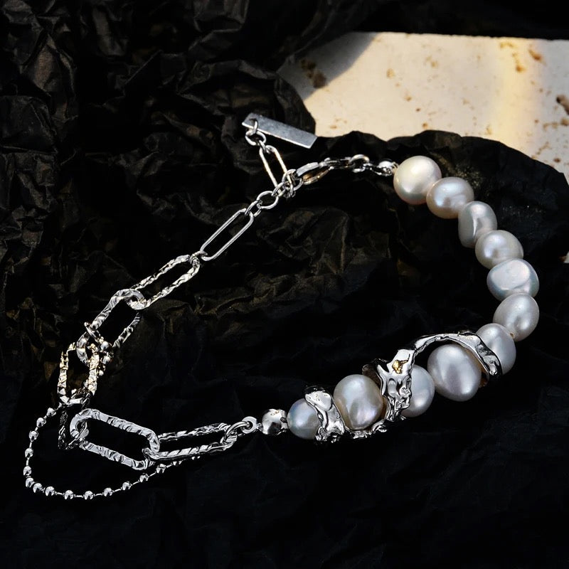 Silver irregular bracelet with pearls.