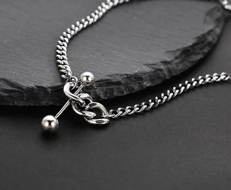 Silver necklace with decorative elements.