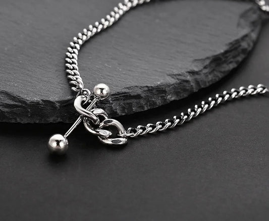 Silver necklace with decorative elements.