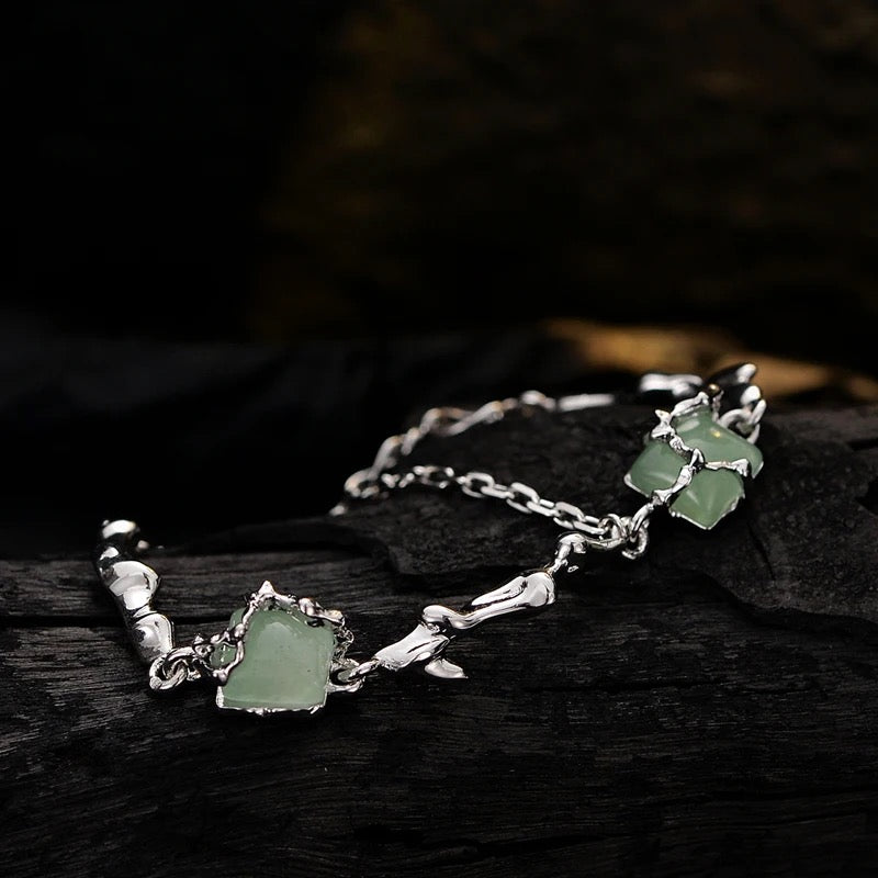 Silver bracelet with green jades.